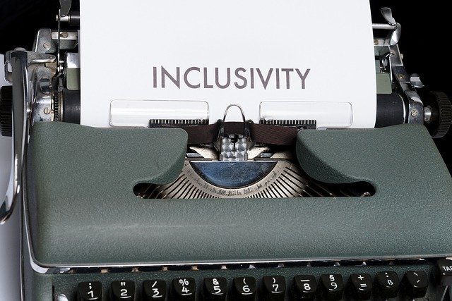 An old fashioned typewriter has a piece of paper in it that says inclusivity.